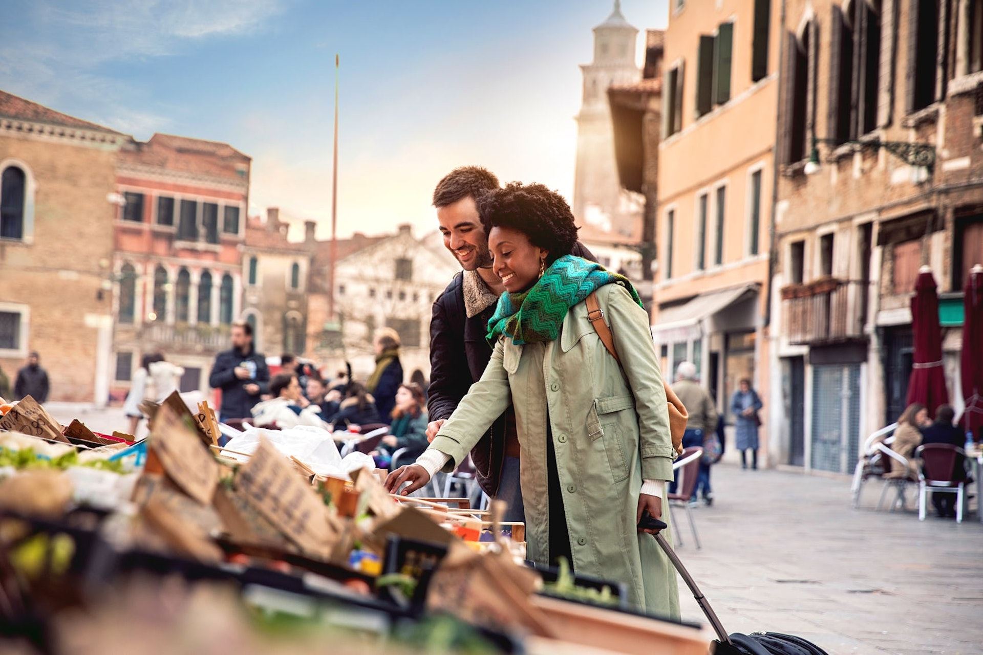 A couple shopping together at an outdoor fruit market in Venice